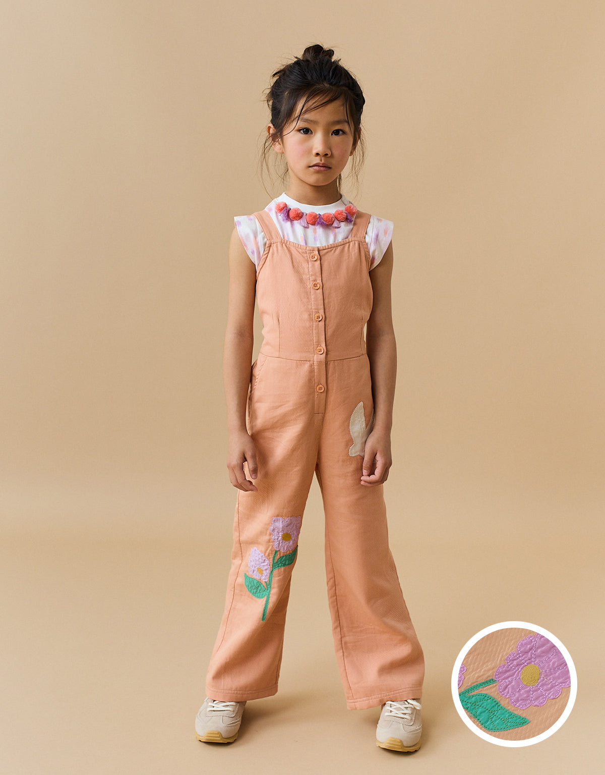 EUNICE STRAPPY JUMPSUIT WITH FRONT BUTTONS AND APPLIQUES