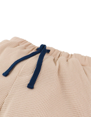 Flatlay front view of the Scottie Shorts with Welt Pockets with waffle knit fabric and pocket details from the streetwear-inspired collection of Filipino kids fashion brand Gingersnaps Philippines.
