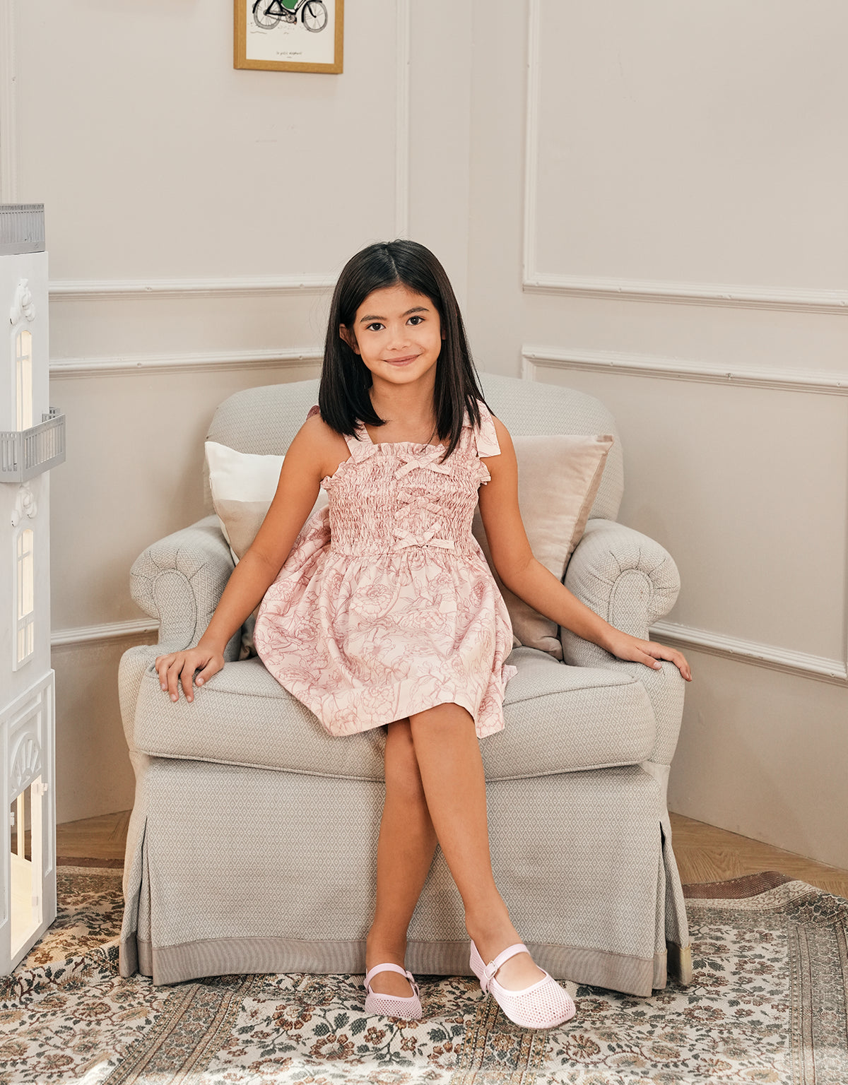 Campaign photo of girl wearing the Floral Toile Print Dress with Smocked and Velvet Bows Bodice, blending classic romance