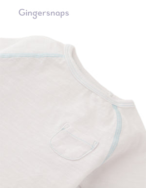 Details front photo of Baby Kevin Jersey Raglan Tee in white showing breathable cotton slub fabric and raglan sleeve seams for easy movement, from the Holiday collection of Filipino kids fashion brand Gingersnaps Philippines.