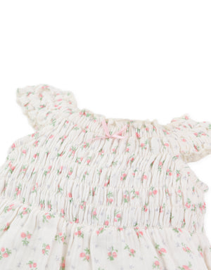 Close-up front detail of floral print smocking with ribbon tie accents From Gingersnaps Floral Grace Collection