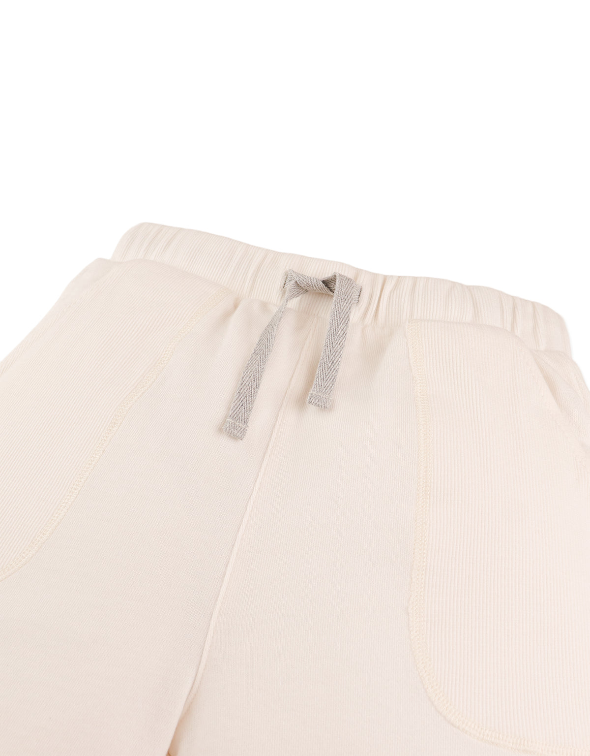 Detail front photo of Miles Pull-On Shorts in off-white, focusing on the elastic waistband and cotton fabric surface, from the Holiday collection of Filipino kids fashion brand Gingersnaps Philippines.