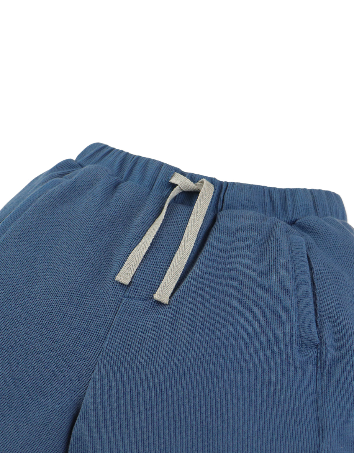 Detail front photo of Eliot Shorts in blue with side pockets, focusing on the pocket opening and waistband detail, from the Holiday collection of Filipino kids fashion brand Gingersnaps Philippines.