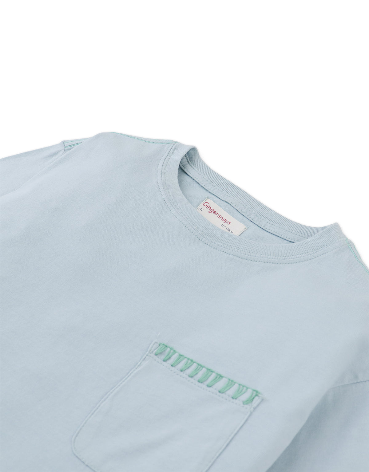 Details front photo of Casper Tee with stitched pocket in soft light blue, showing delicate stitchwork and pocket detail, from the Holiday collection of Filipino kids fashion brand Gingersnaps Philippines.