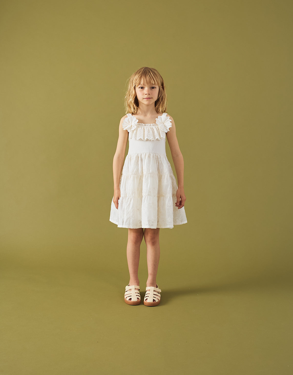 Campaign photo of the Addison Dress with Corsage & Tiered Skirt for kids from the Spring Summer collection of Filipino kids fashion brand Gingersnaps Philippines, featuring an off-white palette, corsage accent, and tiered floral skirt.