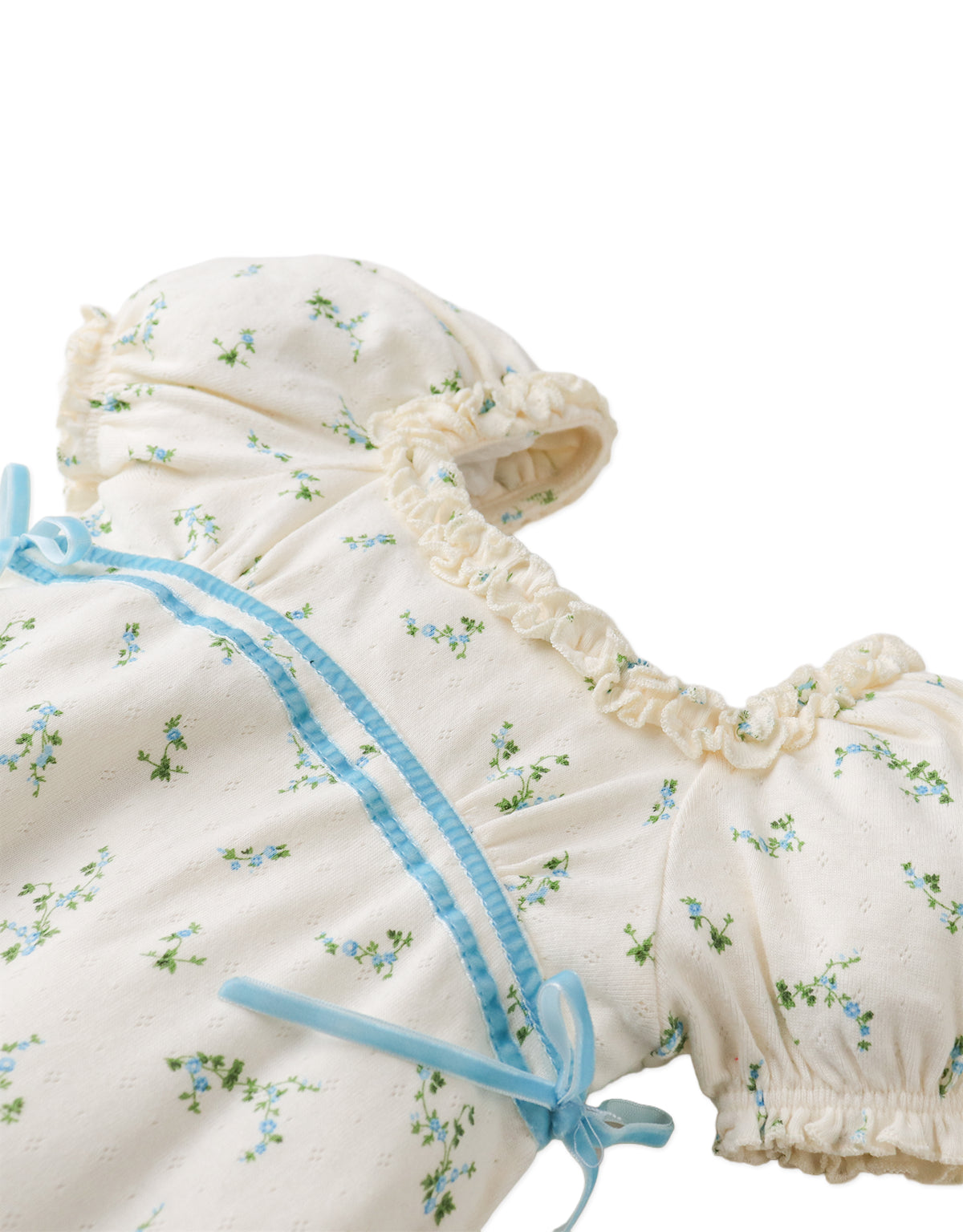 Flatlay front view of the Giselle Dress showcasing its floral pattern, puff sleeves, and ribbon accent.
