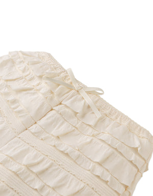 Flatlay front view of the Brielle Shorts showcasing their soft pastel tone and playful volume.