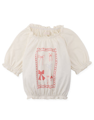 Details front photo of Maru T-Shirt with puff sleeves bow spot print, showing playful bow spot pattern and gently gathered puff sleeves, from the Holiday collection of Filipino kids fashion brand Gingersnaps Philippines.