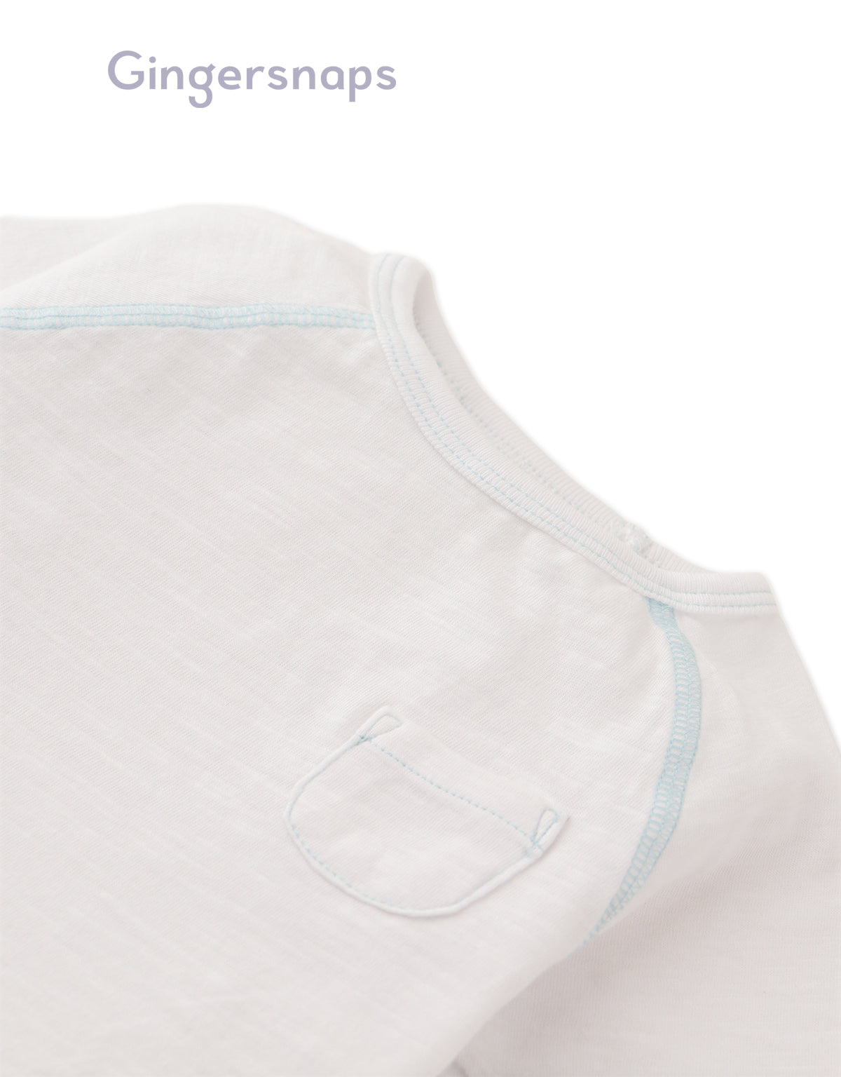 Details front photo of Baby Kevin Jersey Raglan Tee in white showing breathable cotton slub fabric and raglan sleeve seams for easy movement, from the Holiday collection of Filipino kids fashion brand Gingersnaps Philippines.